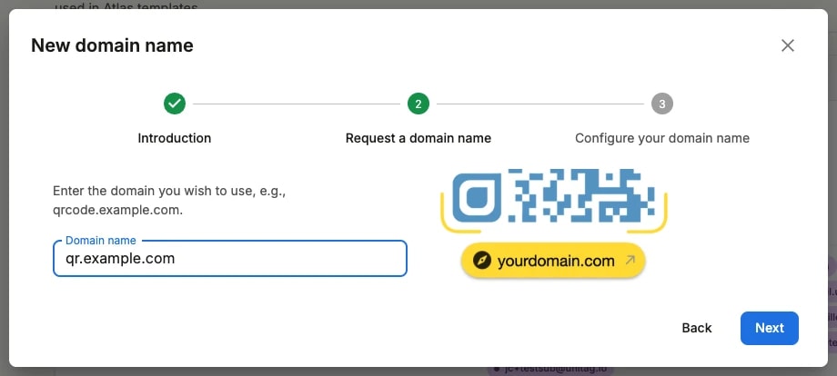 Step two of the wizard: the Domain name field filled with qr.example.com, beside an illustration of a branded short URL Step two of the wizard: the Domain name field filled with qr.example.com, beside an illustration of a branded short URL